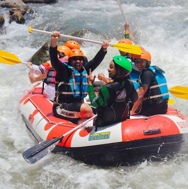 A group of people white water rafting.