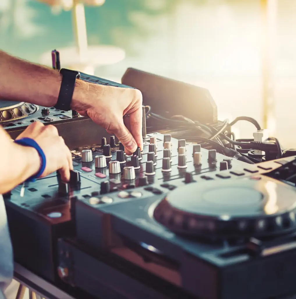 Close up of hands mixing on a DJ board